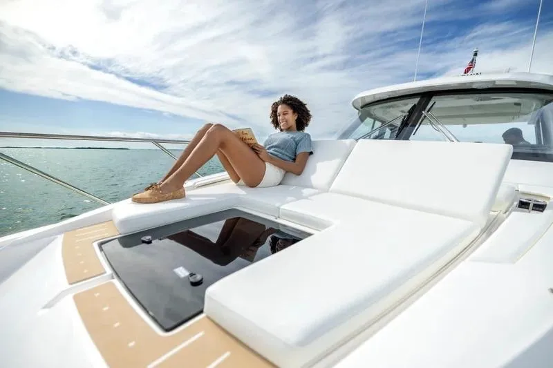 Slide: The Image of Woman relaxing on 2027 Tiara Yachts 39 LE, enjoying sunny day on the water. - 2