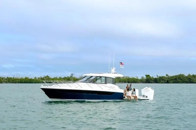 Slide: The Image of 2027 Tiara Yachts 39 LE cruising on calm waters with passengers onboard. - 5