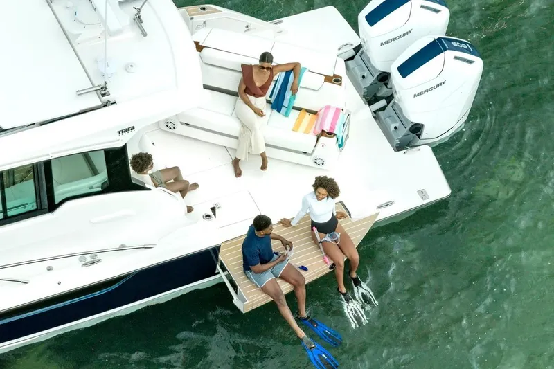 Slide: The Image of People relaxing on a 2027 Tiara Yachts 39 LE, enjoying the water. - 6