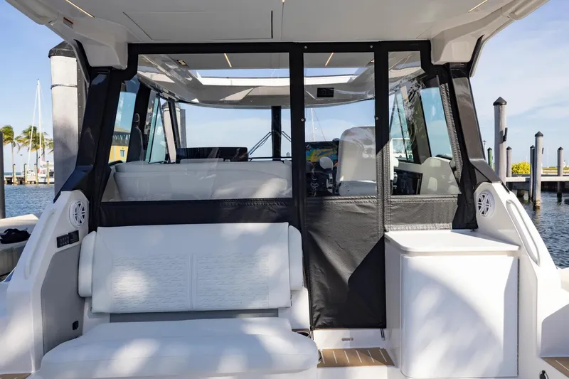 Slide: The Image of Manufacturer Provided Image: 2026 Tiara Yachts 39 LE interior with seating and helm, docked by the water. - 9