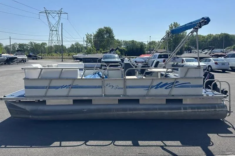 Slide: The Image of Pontoon boat "Playtime" DL2022, 2002 model, parked in a lot under clear skies. - 10