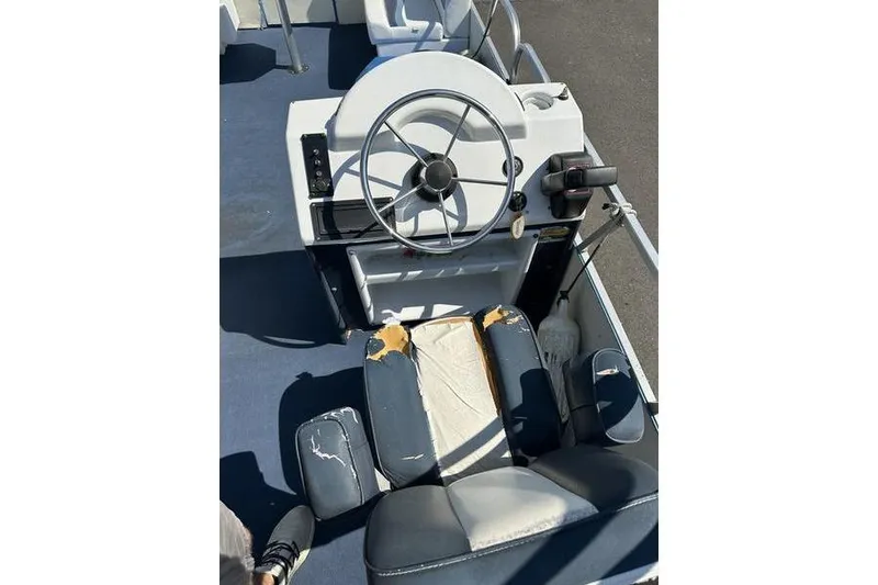 Slide: The Image of Steering console of a 2002 Playtime DL2022 boat with worn seating. - 11