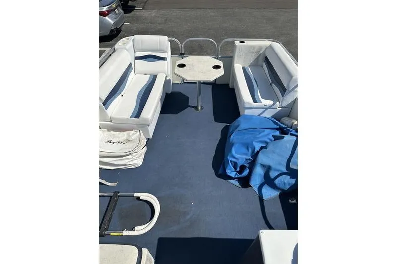 Slide: The Image of Interior of a 2002 Playtime DL2022 boat with white seating and blue flooring. - 3