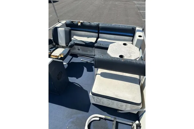 Slide: The Image of Interior of a 2002 Playtime DL2022 boat with worn seating and table. - 5