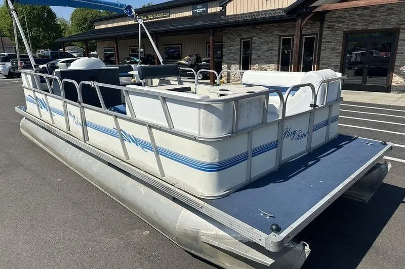 Slide: The Image of Pontoon boat Playtime DL2022, 2002 model, parked outdoors near a building. - 9