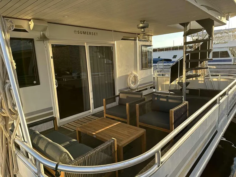Slide: The Image of 2005 Sumerset Top Hat houseboat with outdoor seating and spiral staircase. - 1