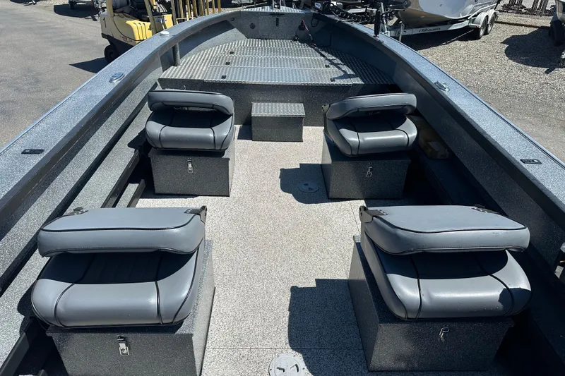 Slide: The Image of 2024 Alumaweld Columbia 25 boat interior with four cushioned seats and storage compartments. - 11