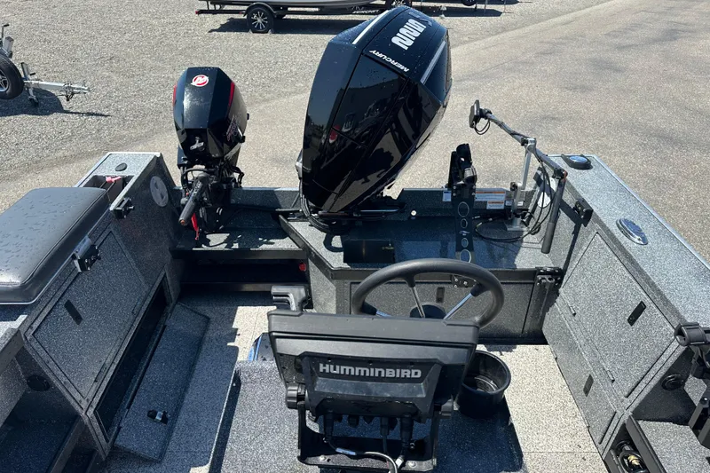 Slide: The Image of 2024 Alumaweld Columbia 25 boat interior with dual outboard motors and Humminbird navigation system. - 5