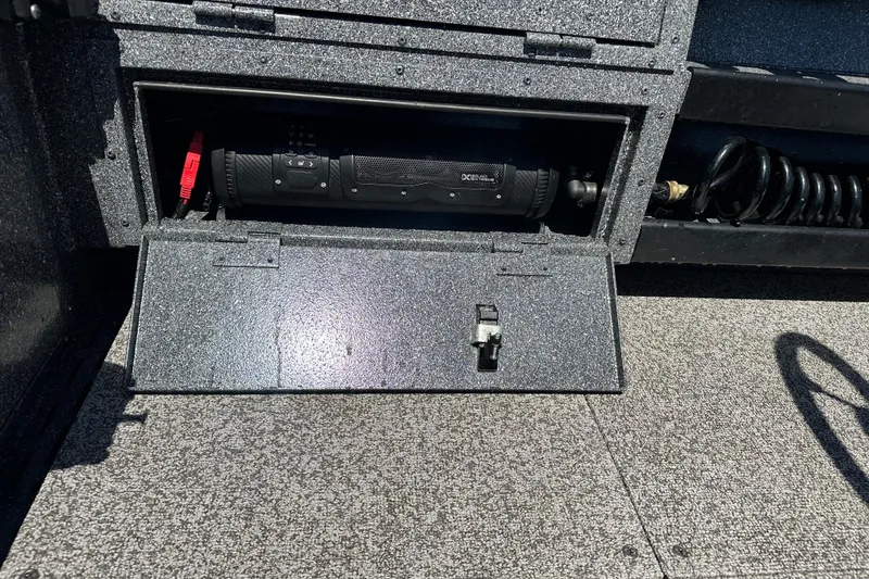 Slide: The Image of Storage compartment in 2024 Alumaweld Columbia 25 boat, featuring secure latch and interior equipment. - 9