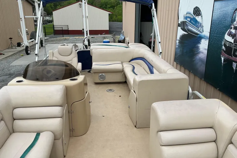 Slide: The Image of Interior view of a 2012 Godfrey Sweetwater 2486 C pontoon boat with beige seating. - 3