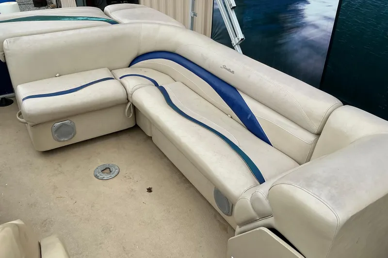 Slide: The Image of 2012 Godfrey Sweetwater 2486 C boat seating with beige and blue upholstery. - 4