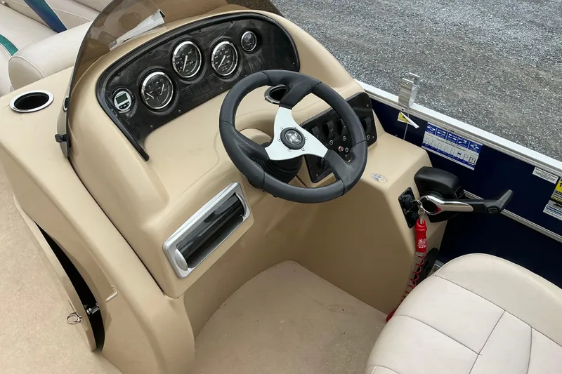 Slide: The Image of 2012 Godfrey Sweetwater 2486 C boat dashboard with steering wheel and control panel. - 5