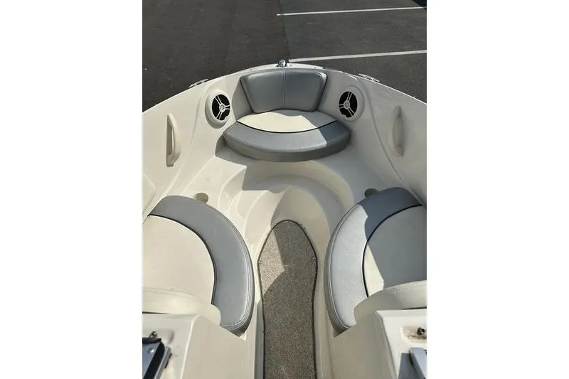 Slide: The Image of 2008 Sea Ray 185 Bow Rider interior with gray seating and speakers. - 1