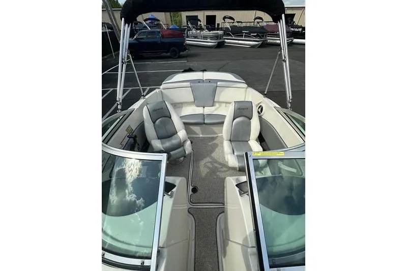 Slide: The Image of 2008 Sea Ray 185 Bow Rider boat interior with seating and windshield. - 13