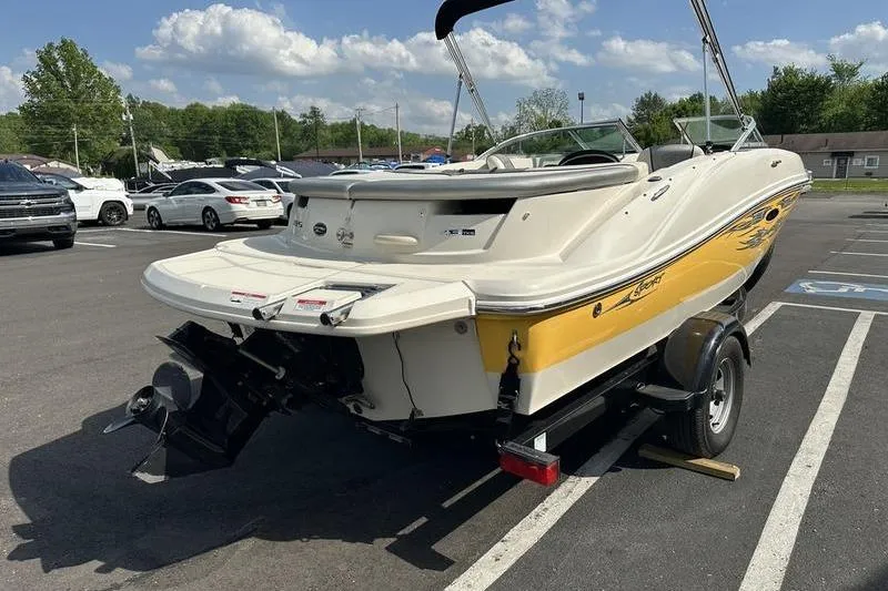 Slide: The Image of 2008 Sea Ray 185 Bow Rider boat on trailer in parking lot, sunny day. - 16