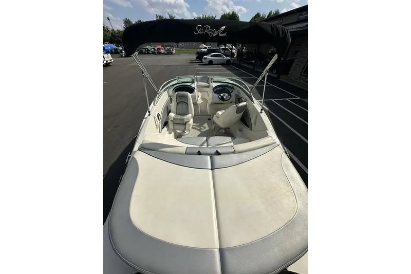 Slide: The Image of 2008 Sea Ray 185 Bow Rider boat with canopy, parked in a lot. - 5