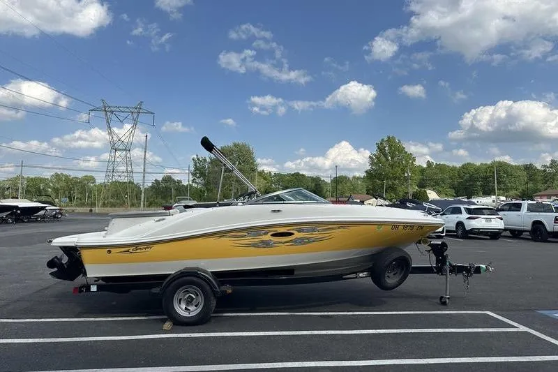 Slide: The Image of 2008 Sea Ray 185 Bow Rider boat on trailer under blue sky. - 9