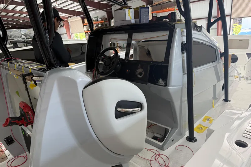 Slide: The Image of 2027 Nor-Tech 390 Sport Center Console under construction in a workshop. - 11