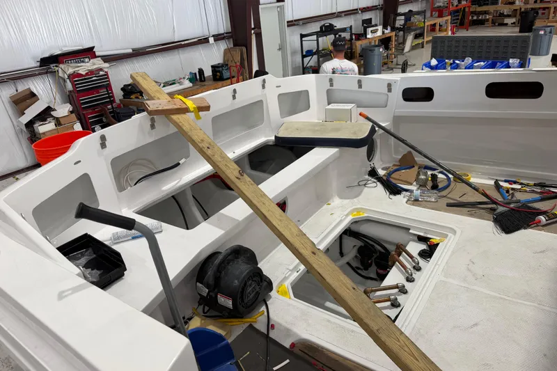 Slide: The Image of 2027 Nor-Tech 390 Sport Center Console under construction in a workshop setting. - 12