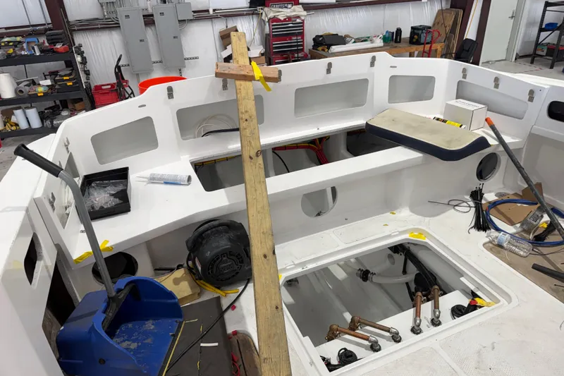 Slide: The Image of Interior view of a 2027 Nor-Tech 390 Sport Center Console under construction. - 16