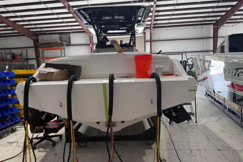 Slide: The Image of 2027 Nor-Tech 390 Sport Center Console in a workshop, under maintenance. - 7