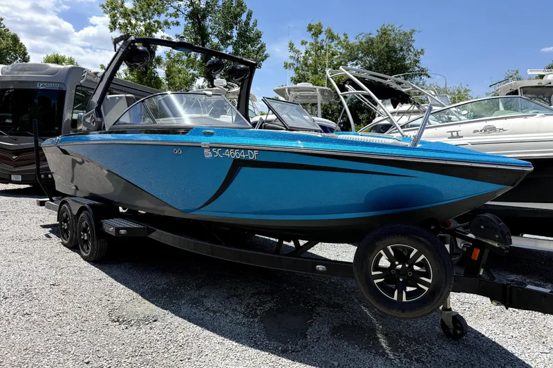 The Image of 2017 Tigé Z3 boat in vibrant blue on a trailer, parked outdoors. - 1