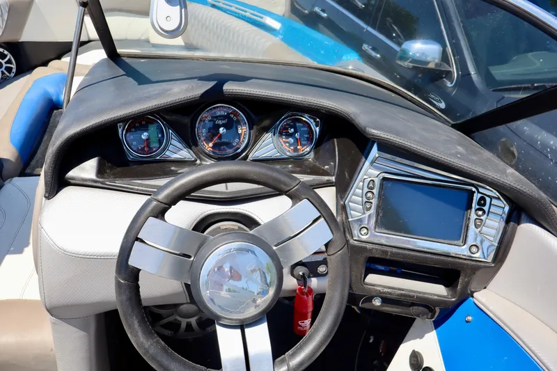 Slide: The Image of Interior dashboard of a 2017 Tigé Z3 boat with steering wheel and gauges. - 3