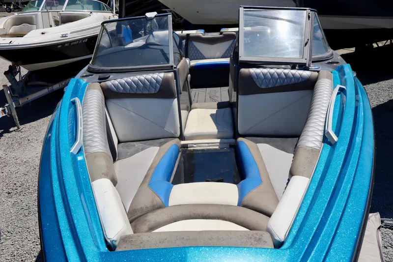 Slide: The Image of 2017 Tigé Z3 boat interior with blue and gray seating, parked on gravel. - 5
