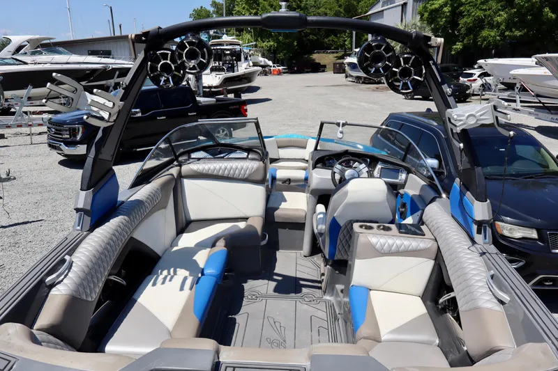 Slide: The Image of 2017 Tigé Z3 boat interior with luxury seating and modern dashboard in a marina setting. - 6