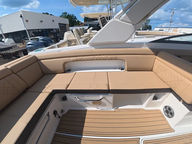 Slide: The Image of The image shows the seating area of a Sea Ray SDX 290 Outboard boat with beige upholstery. - 7