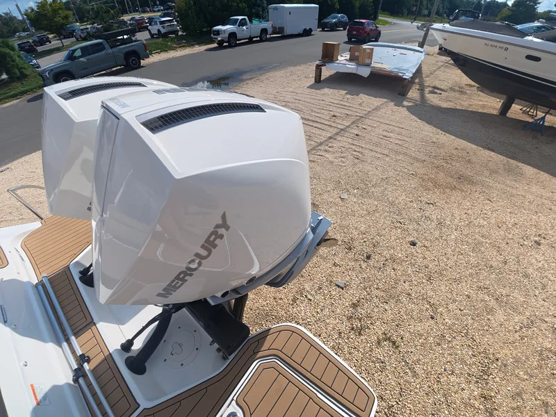 Slide: The Image of Two Mercury outboard engines on a Sea Ray SDX 290 boat, parked on a gravel lot. - 2
