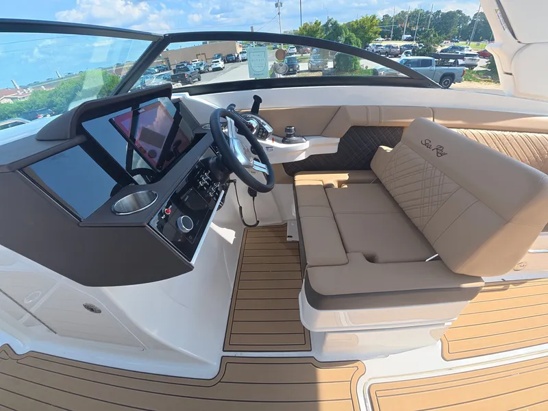 Slide: The Image of The image shows the cockpit of a 2027 Sea Ray SDX 290 Outboard with modern instruments and comfortable seating. - 19