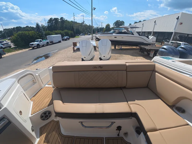 Slide: The Image of The image shows the cockpit of a 2027 Sea Ray SDX 290 Outboard with beige upholstery. - 6
