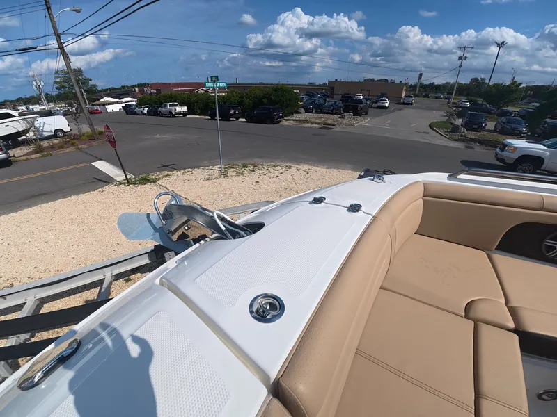 Slide: The Image of The image shows the deck of a 2027 Sea Ray SDX 290 Outboard with beige seating. - 23