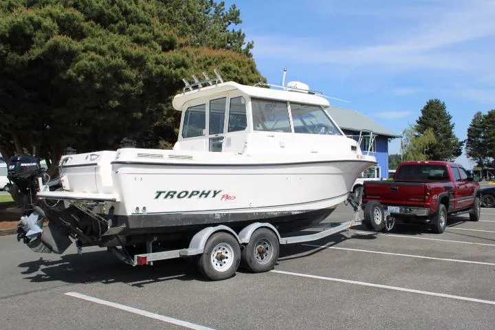 Slide: The Image of 2006 Trophy 2359 Pro boat on trailer, parked in lot, sunny day. - 1