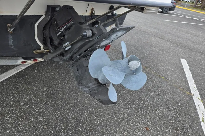 Slide: The Image of 2006 Trophy 2359 Pro boat with MerCruiser outdrive and propeller in a parking lot. - 11