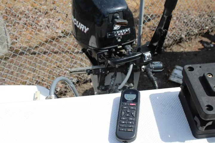 Slide: The Image of 2006 Trophy 2359 Pro boat engine with remote control on deck. - 13