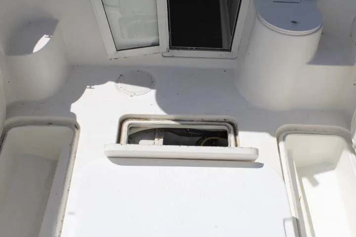 Slide: The Image of 2006 Trophy 2359 Pro boat interior with storage compartments and seating area. - 16