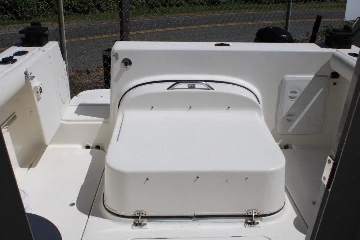 Slide: The Image of 2006 Trophy 2359 Pro boat interior with white seating and storage compartment. - 17