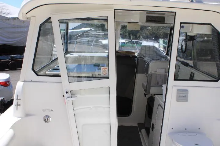 Slide: The Image of 2006 Trophy 2359 Pro boat cabin with glass doors and interior view. - 22