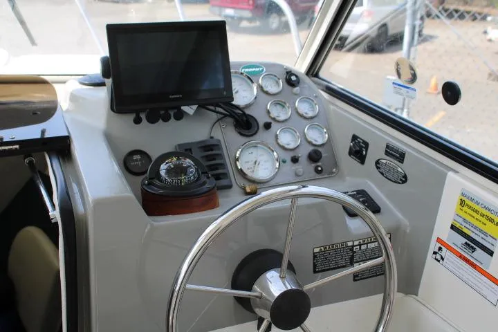 Slide: The Image of Helm of 2006 Trophy 2359 Pro boat with steering wheel, gauges, and navigation equipment. - 25
