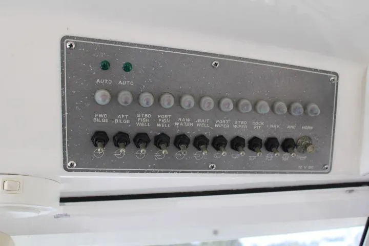 Slide: The Image of Control panel of a 2006 Trophy 2359 Pro boat with labeled switches and indicators. - 33