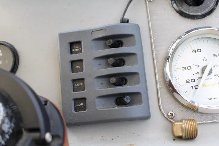 Slide: The Image of Control panel of a 2006 Trophy 2359 Pro boat with switches and speedometer. - 34