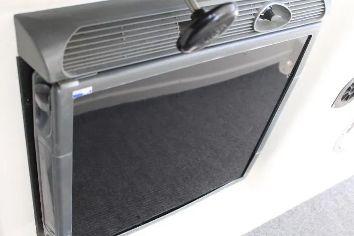 Slide: The Image of 2006 Trophy 2359 Pro boat interior with a closed black panel and handle. - 37