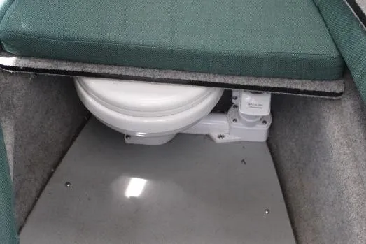 Slide: The Image of 2006 Trophy 2359 Pro boat interior with compact marine toilet under cushioned seat. - 41