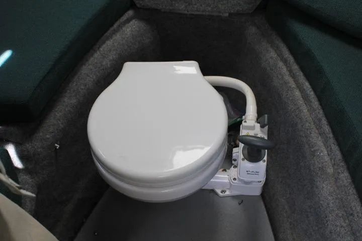 Slide: The Image of 2006 Trophy 2359 Pro boat interior with marine toilet in compact cabin space. - 42