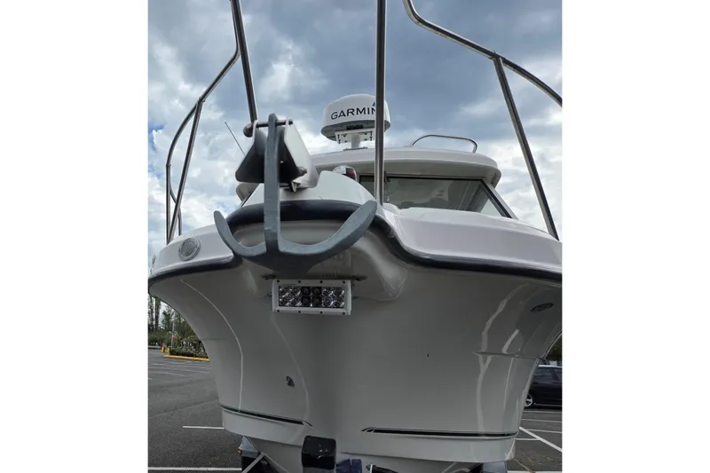 Slide: The Image of 2006 Trophy 2359 Pro boat with Garmin radar, parked under cloudy sky. - 6