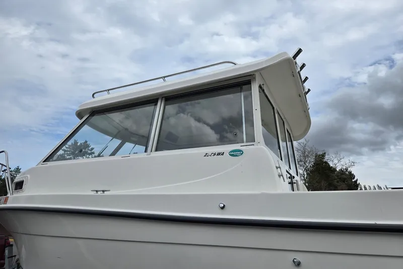 Slide: The Image of 2006 Trophy 2359 Pro boat with cabin, under cloudy sky. - 7
