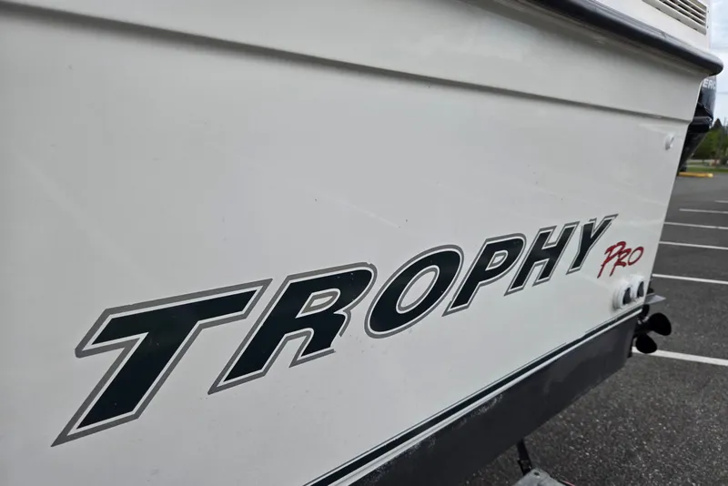 Slide: The Image of Side view of a 2006 Trophy 2359 Pro boat in a parking lot. - 9