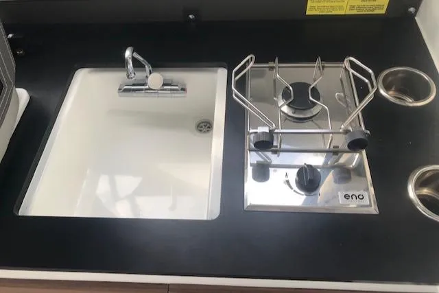 Slide: The Image of Jeanneau NC 795, 2022 kitchen area with sink and stove. - 4